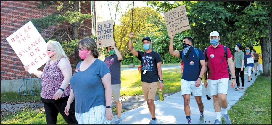 The rally began at Kelly Field — and many participants brought handmade signs. After a speaking program, members of the crowd marched to Milton High School