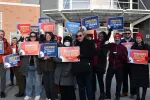 Educators and MTA leaders, including President Max Page, gathered outside a Revere middle school in March as part of a series of "walk-ins" throughout the state to protest federal actions.