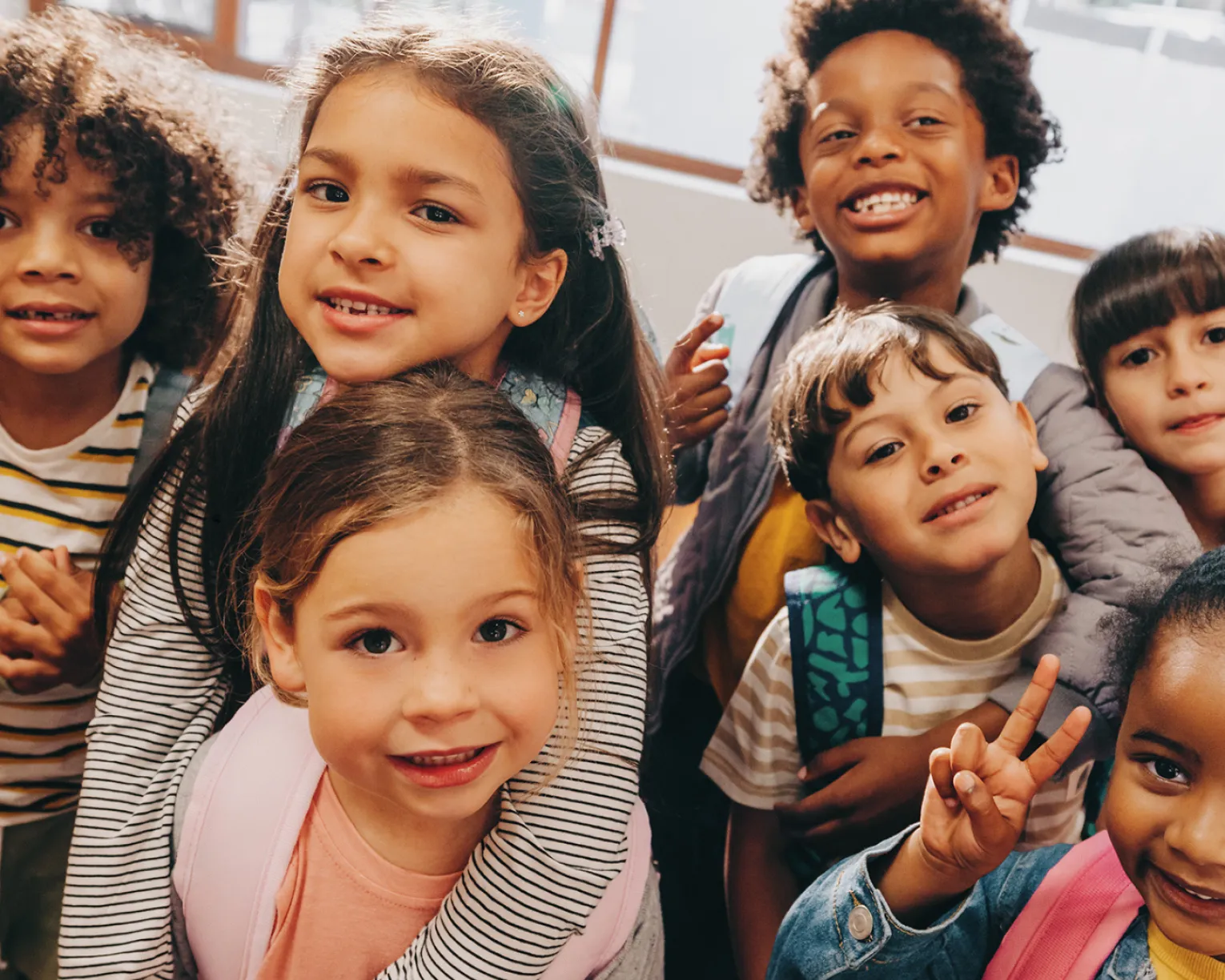 A group of 6-year-old children in a school classroom.