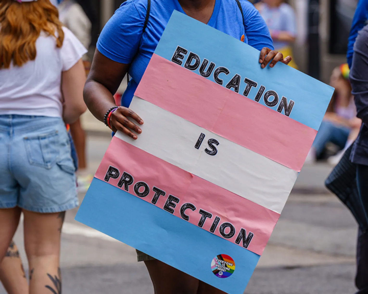 A sign that says, “Education Is Protection.”
