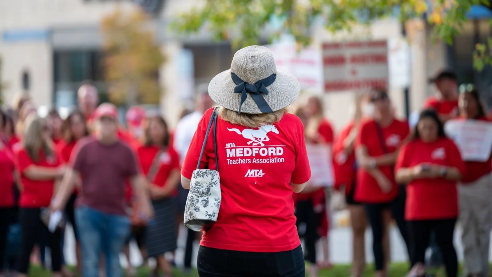 A member of the Medford Education Association rallies for education