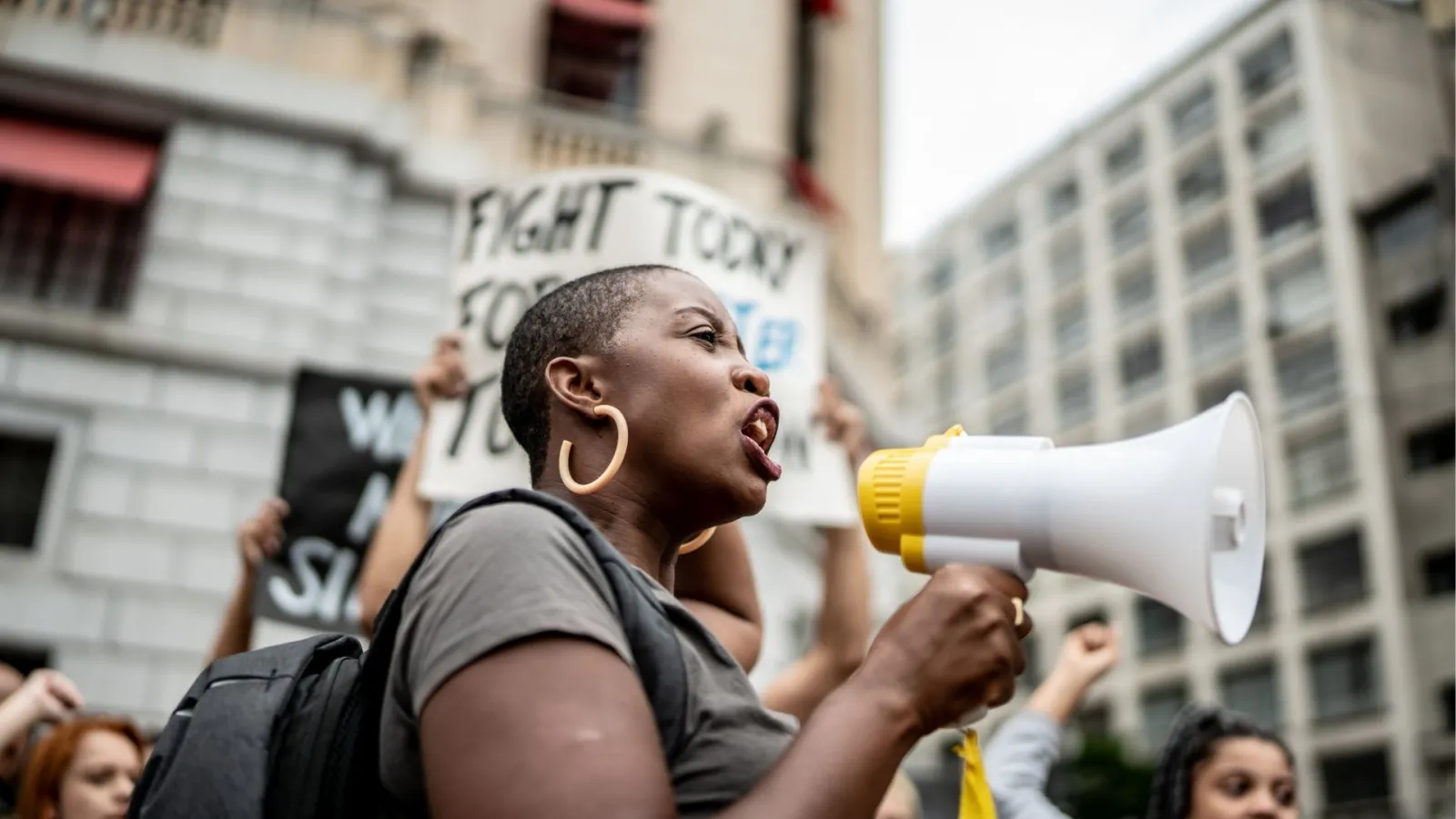 An activist at a rally holding a megaphone.