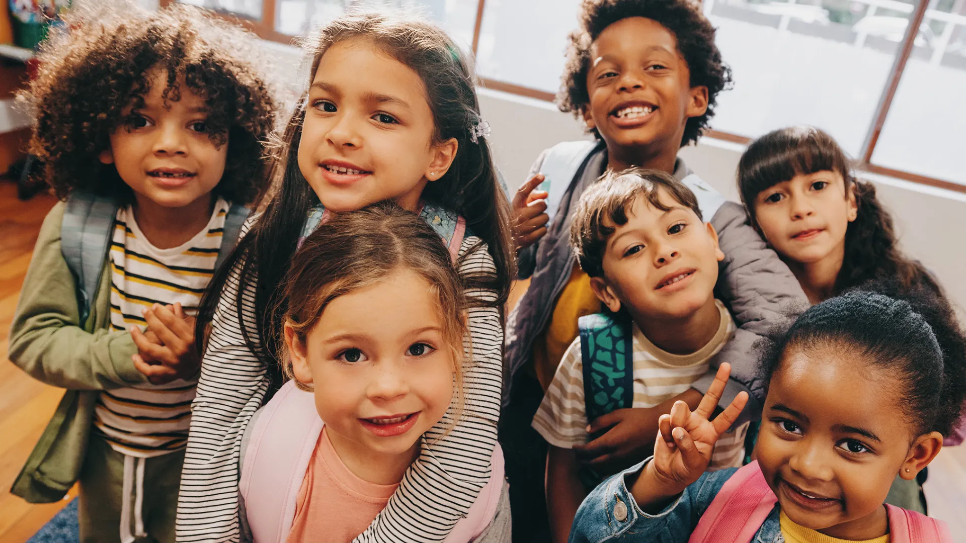 A group of 6-year-old children in a school classroom.