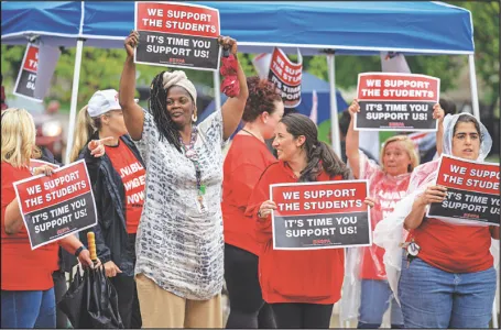 Brockton paraprofessionals rallied outside a public library on June 27, waving signs to build support for a stronger contract. The local is seeking a $25-an-hour starting wage for members.