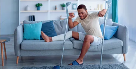 man with crutches and broken leg