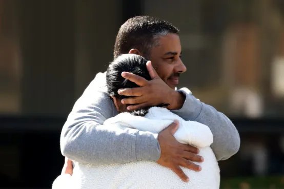 Gustavo, a Milford student, detained; parents shown.